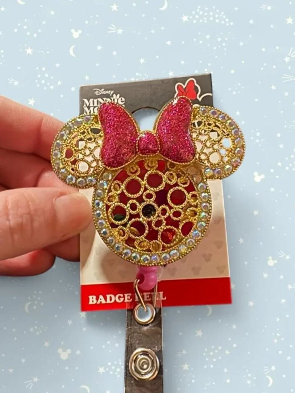 Disney Minnie Mouse badge reel with pink bow, rhinestones and gemstones inside